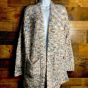 Cream color, speckled cardigan. NWT. Two pockets in the front.